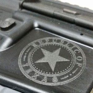 Close up image of Republic of Texas emblem engraved on silver gun