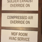 image of phenolic label & wall plates in white with cutout lettering